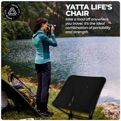 Low back ultralight folding camping chair in army green by a lake, ideal for outdoor adventures.